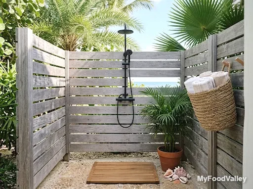 an outdoor shower nook with teak and woven details